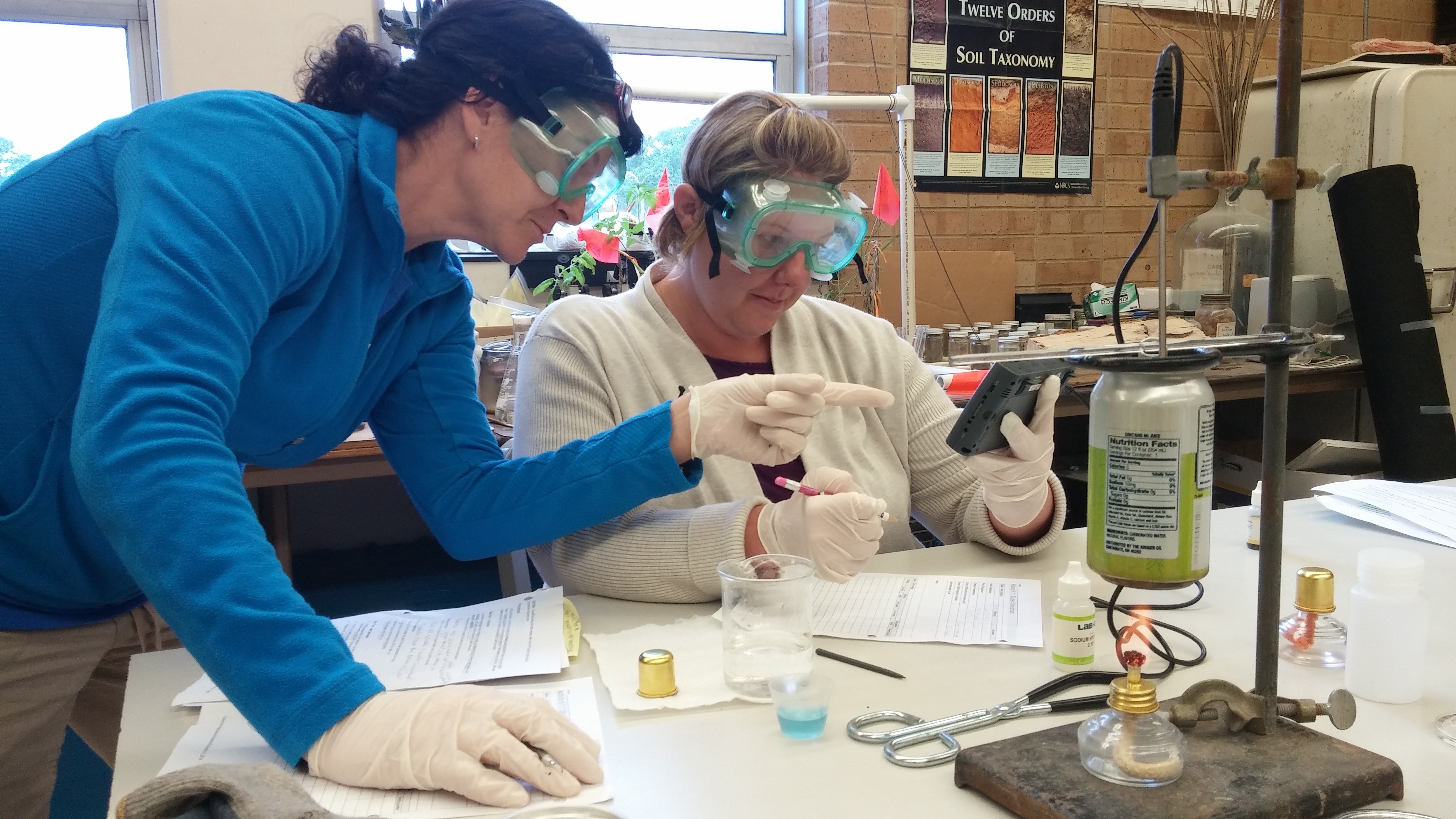 Teacher helps student with science project.