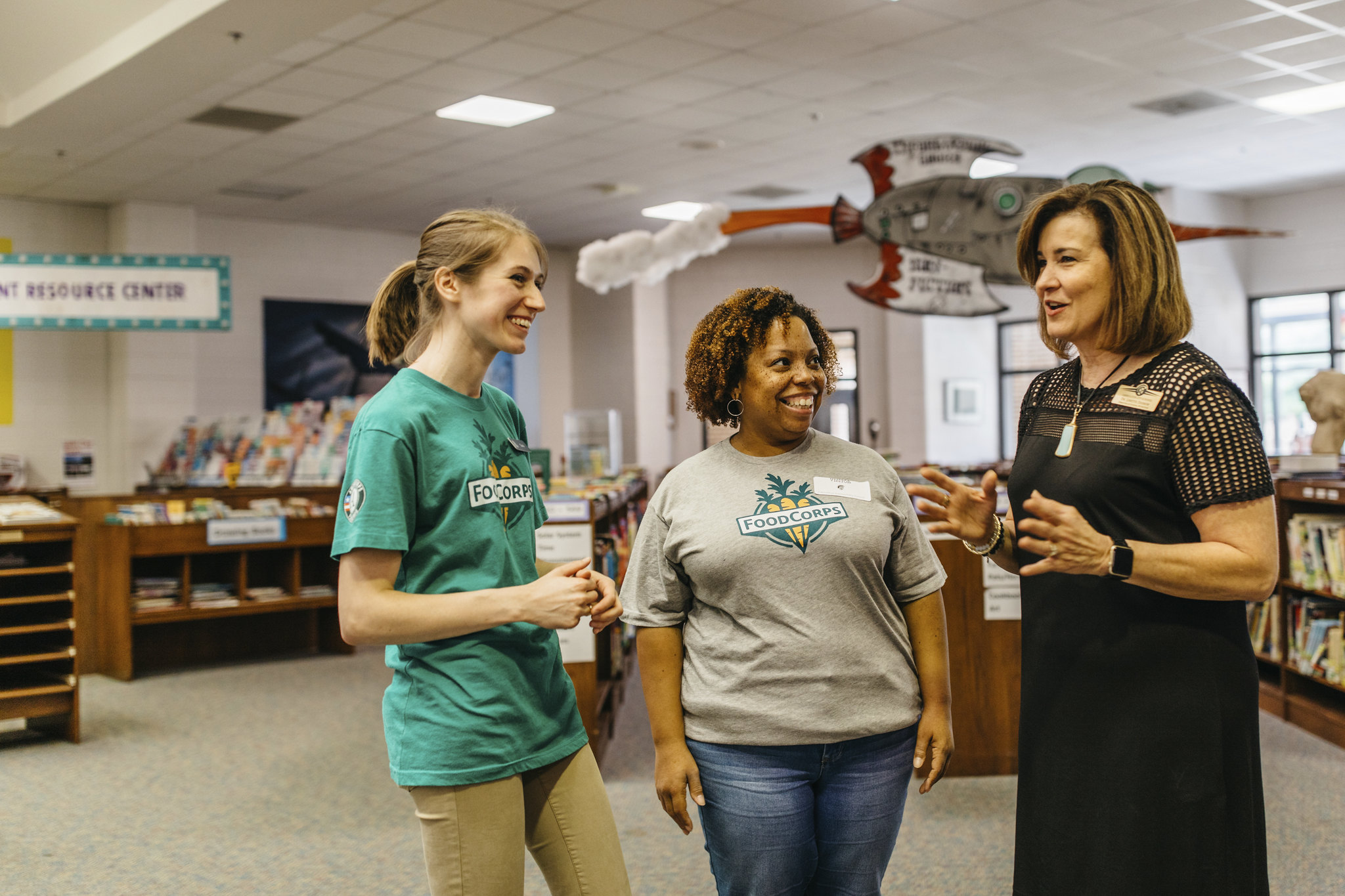 FoodCorps service members speak with a school administrator.