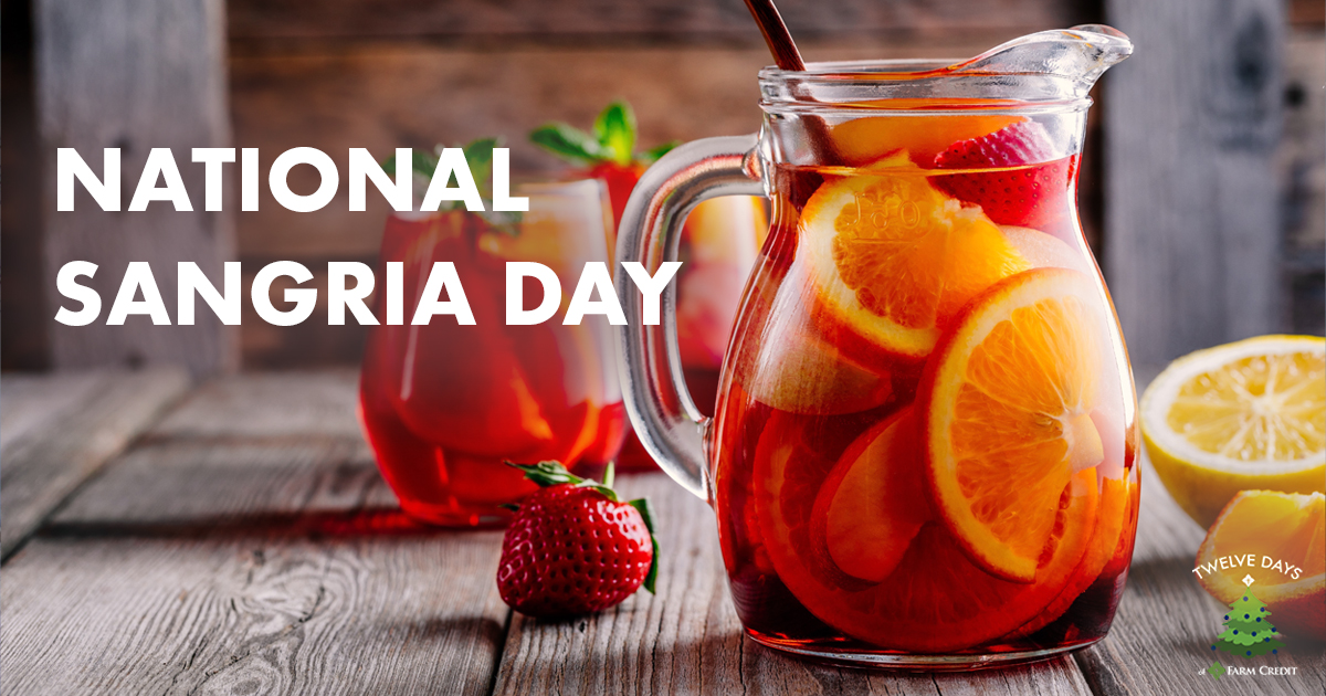 sangria in a glass and pitcher with fruit inside the glass