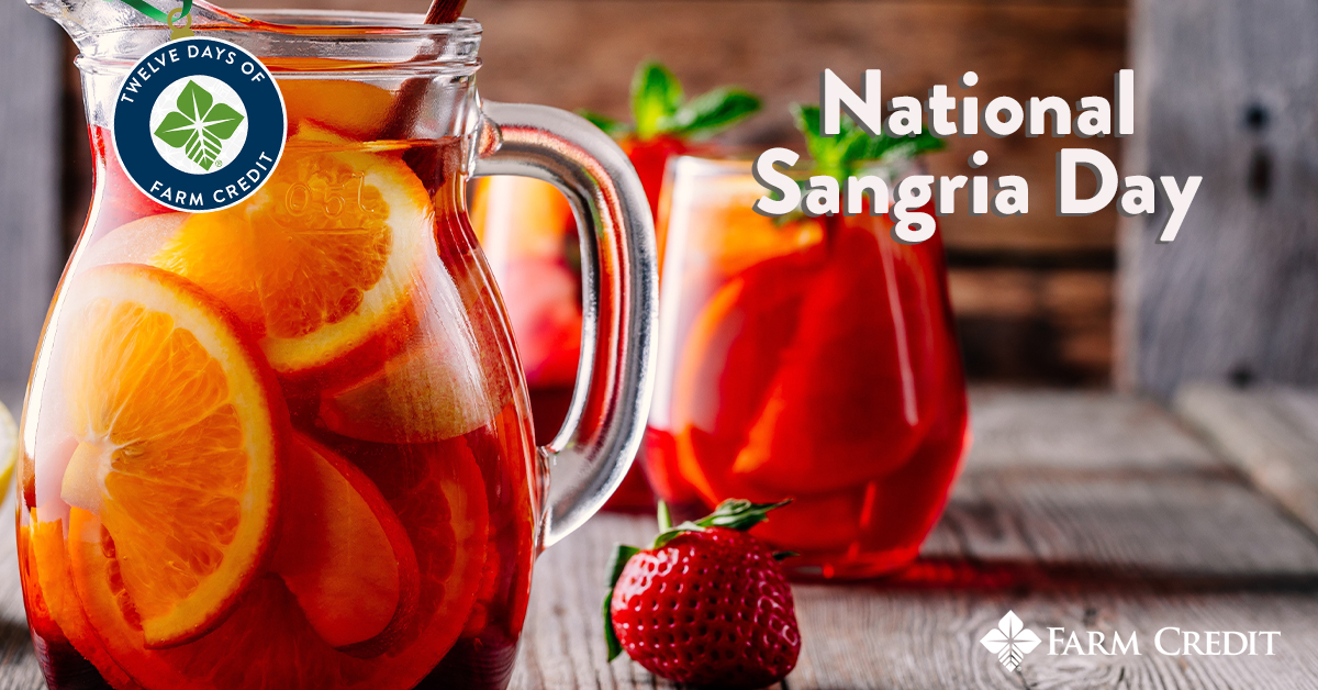 sangria in a glass and pitcher with fruit inside the glass