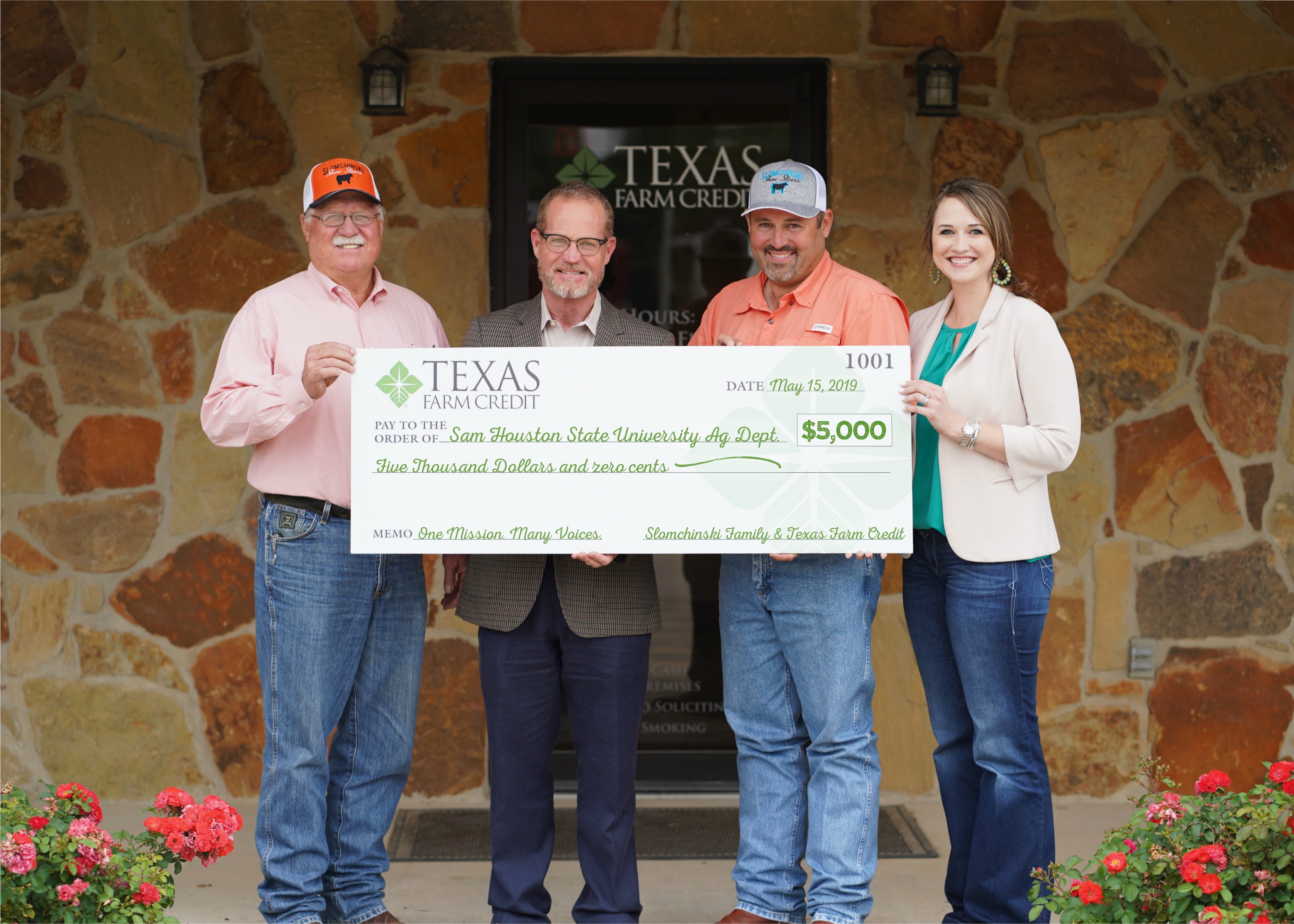 Bill and Brett Slomchinski and Sarah Franklin, their loan officer from Texas Farm Credit, present Sam Houston State University Agriculture Department with a check for $5,000.