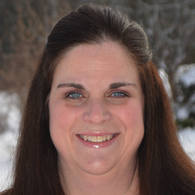 Stacey Sanborn headshot - closeup of a brunette.